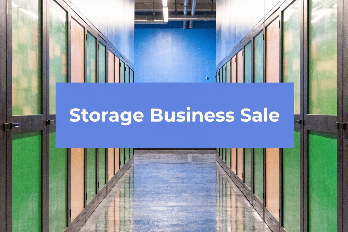 Hallway of a self-storage facility with blue, green, and yellow doors. A blue box with white text in the center reads 